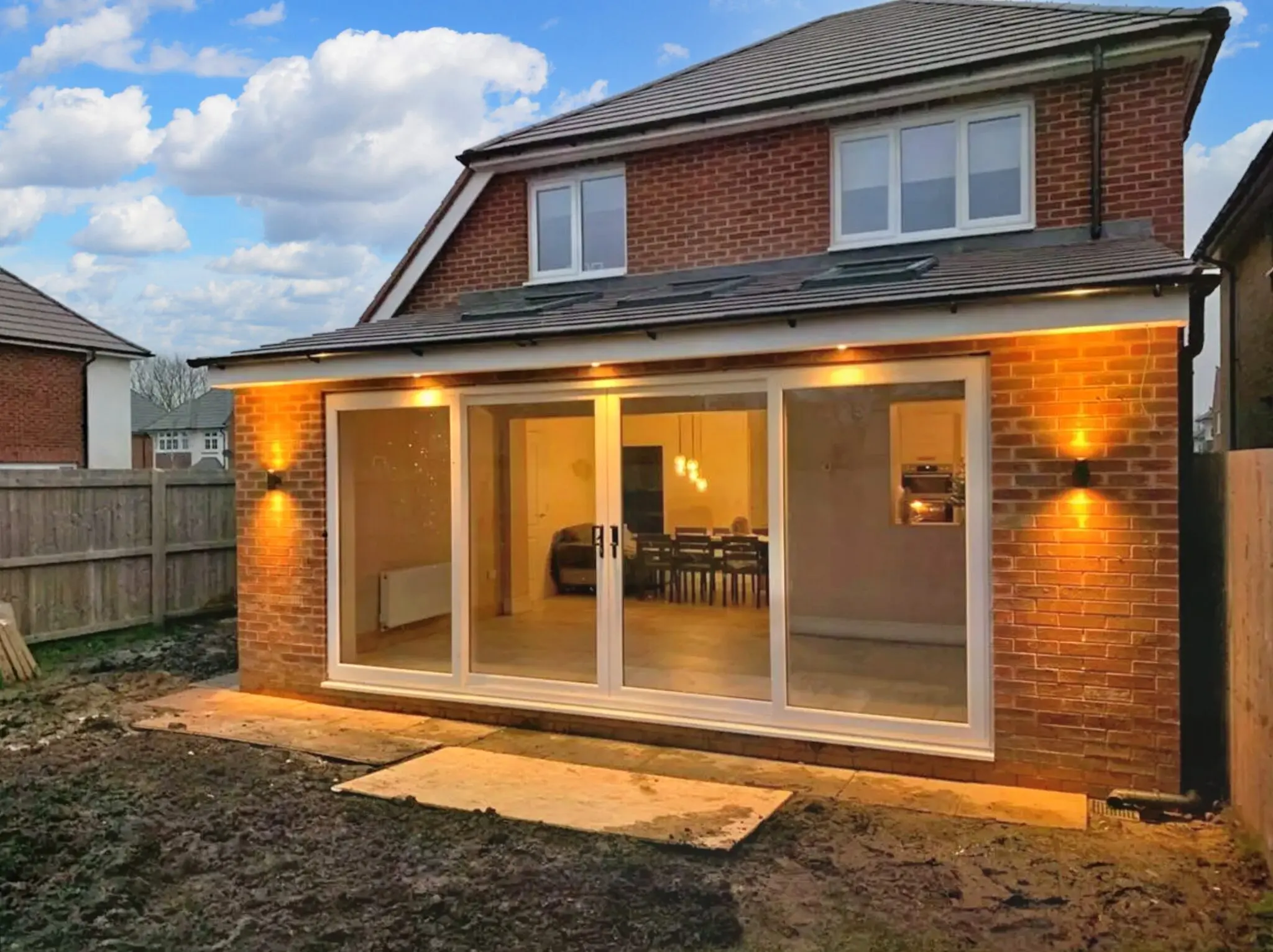 Completed red-brick rear extension with broad glazed doors
